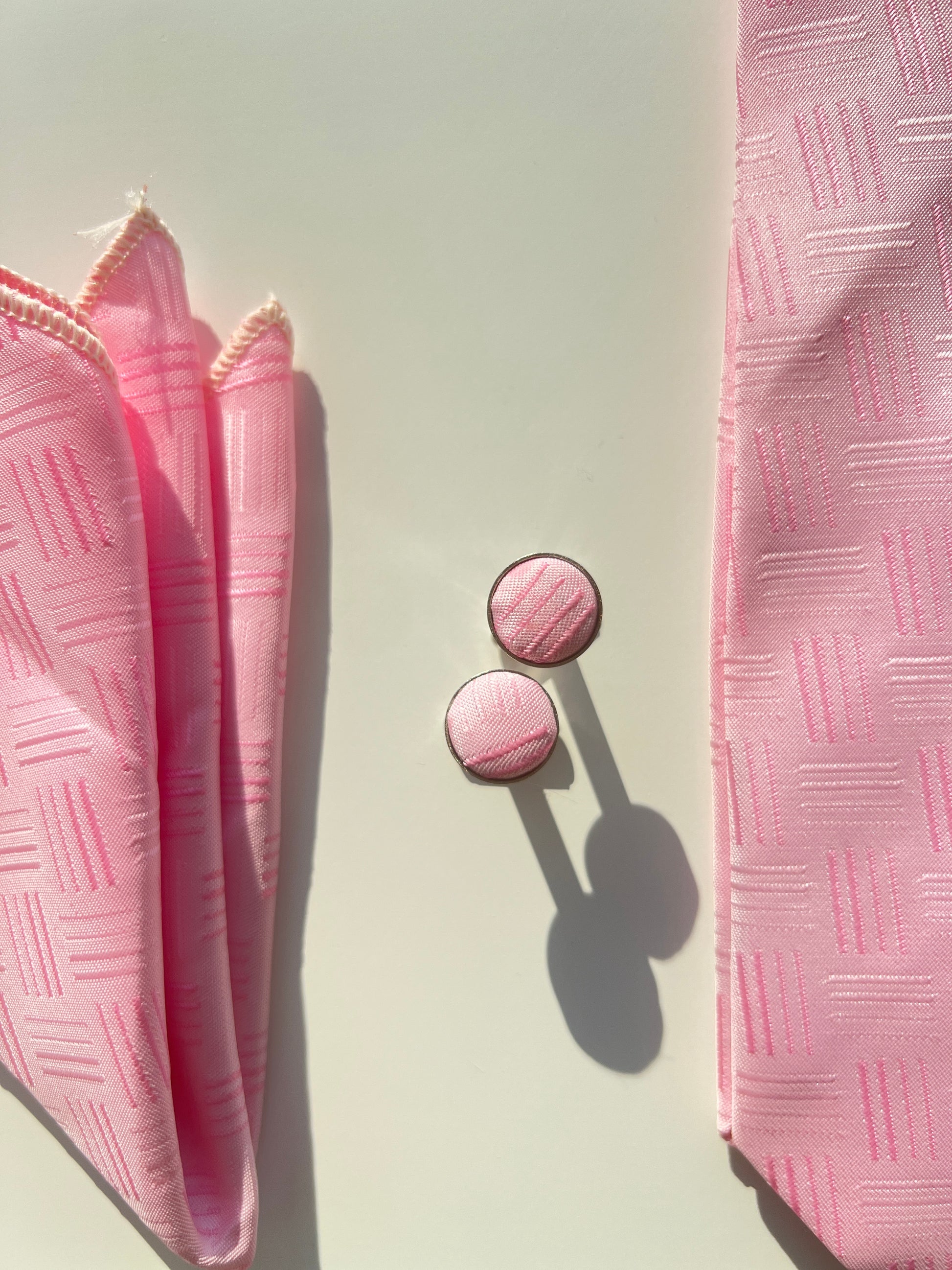 Full display of the pink tie set, showcasing the cohesiveness of the tie, pocket square, and cufflinks