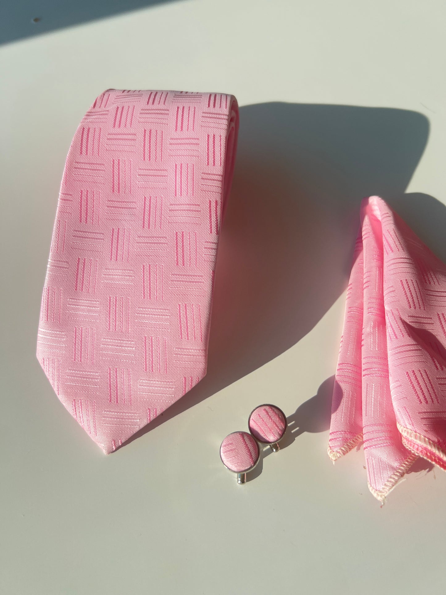 Full display of the pink tie set, showcasing the cohesiveness of the tie, pocket square, and cufflinks