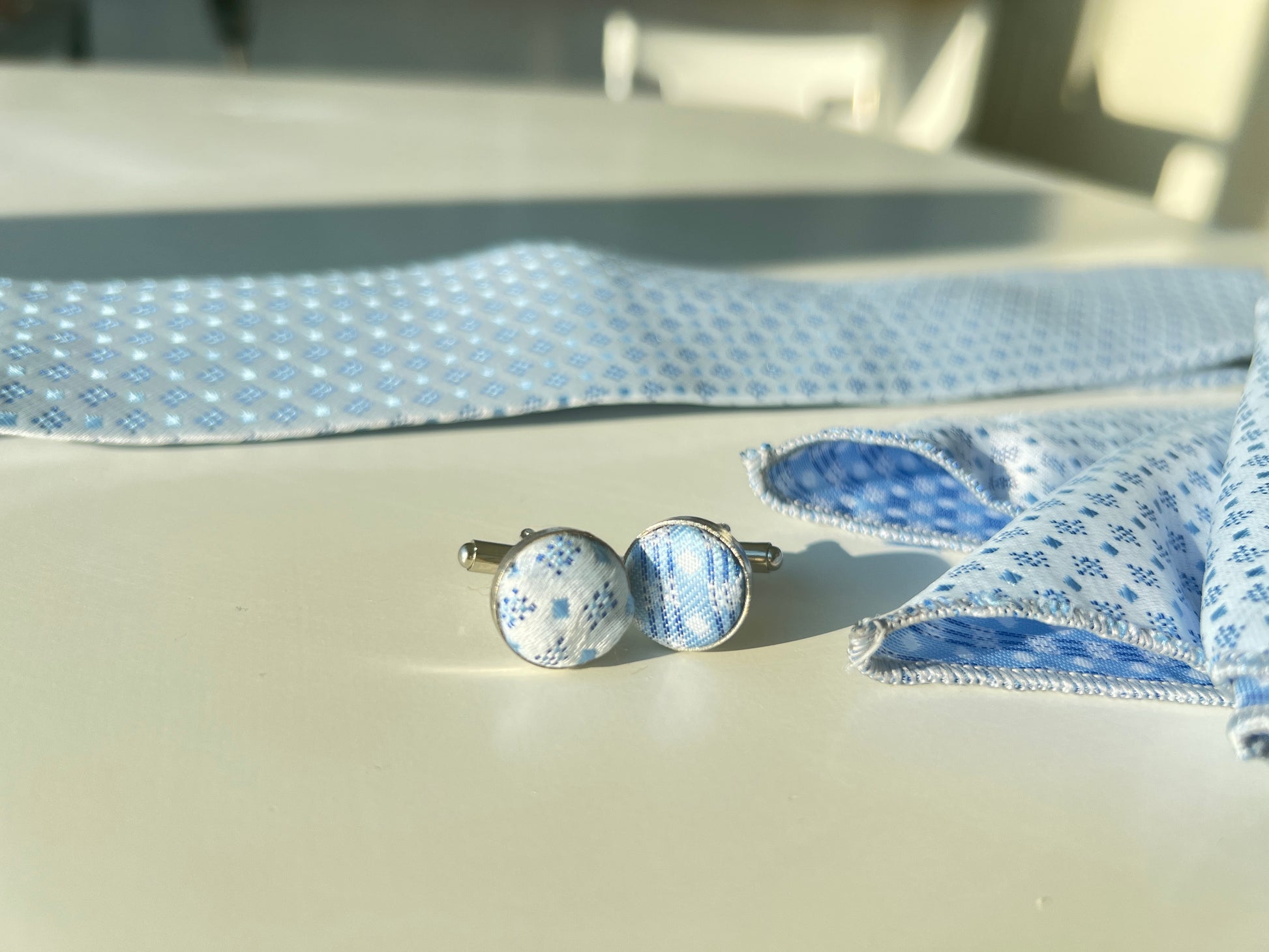 Detailed view of Cufflink's matching blue snowflake pattern