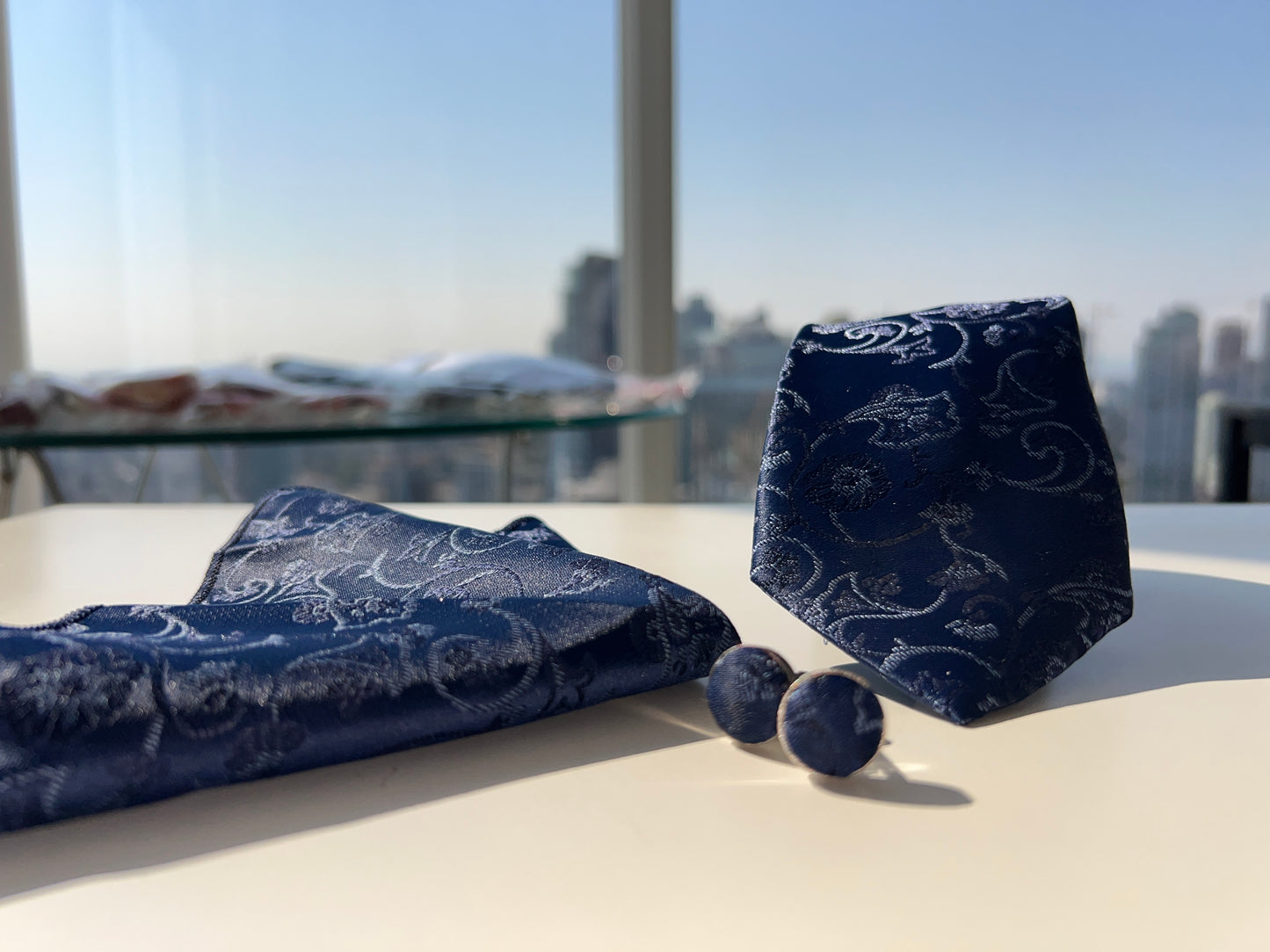 Sophisticated navy blue tie and cufflinks set, captured in natural light for depth of color and detail