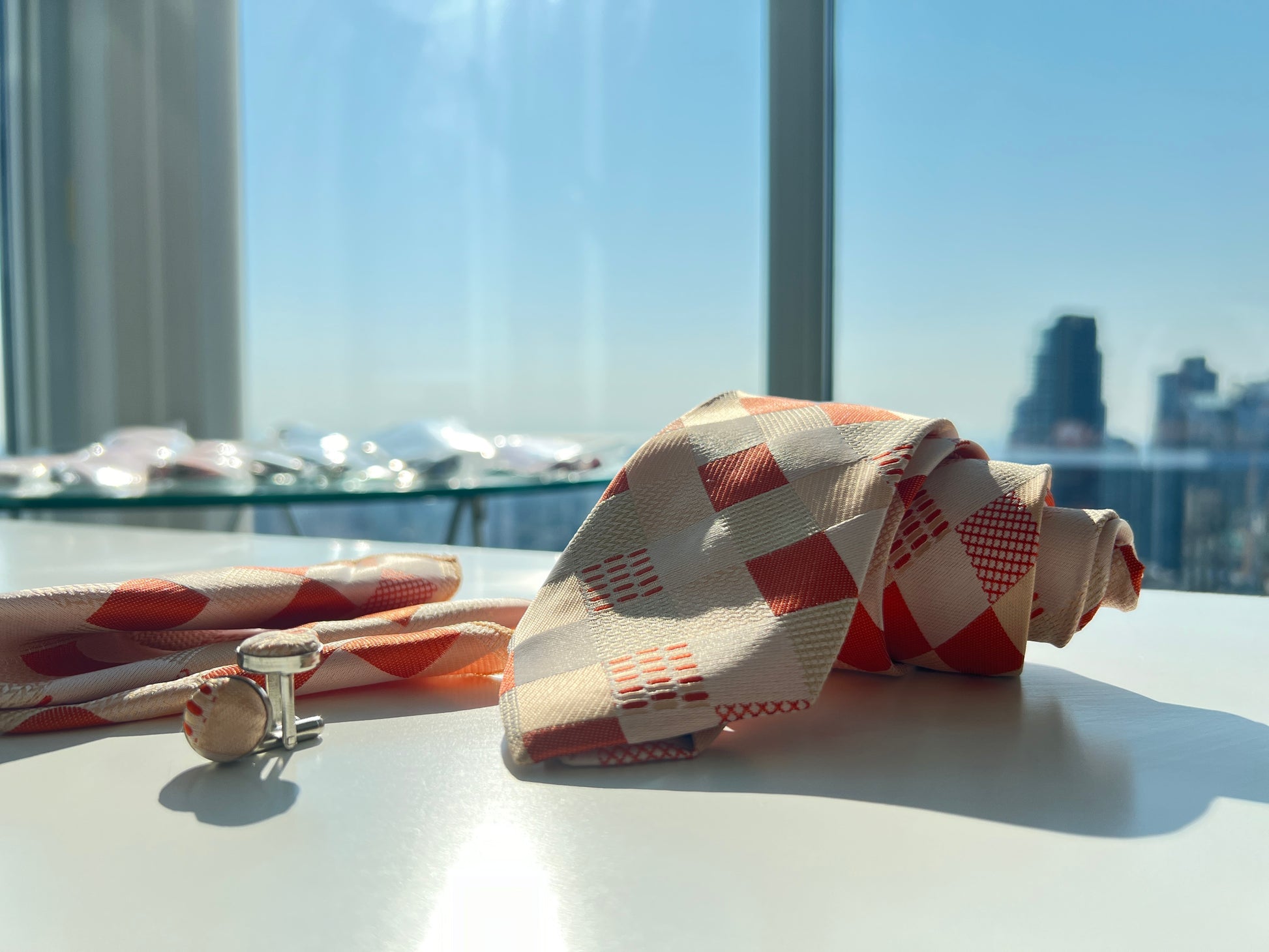 Close-up of orange and beige geometric pattern tie set showing detailed fabric texture