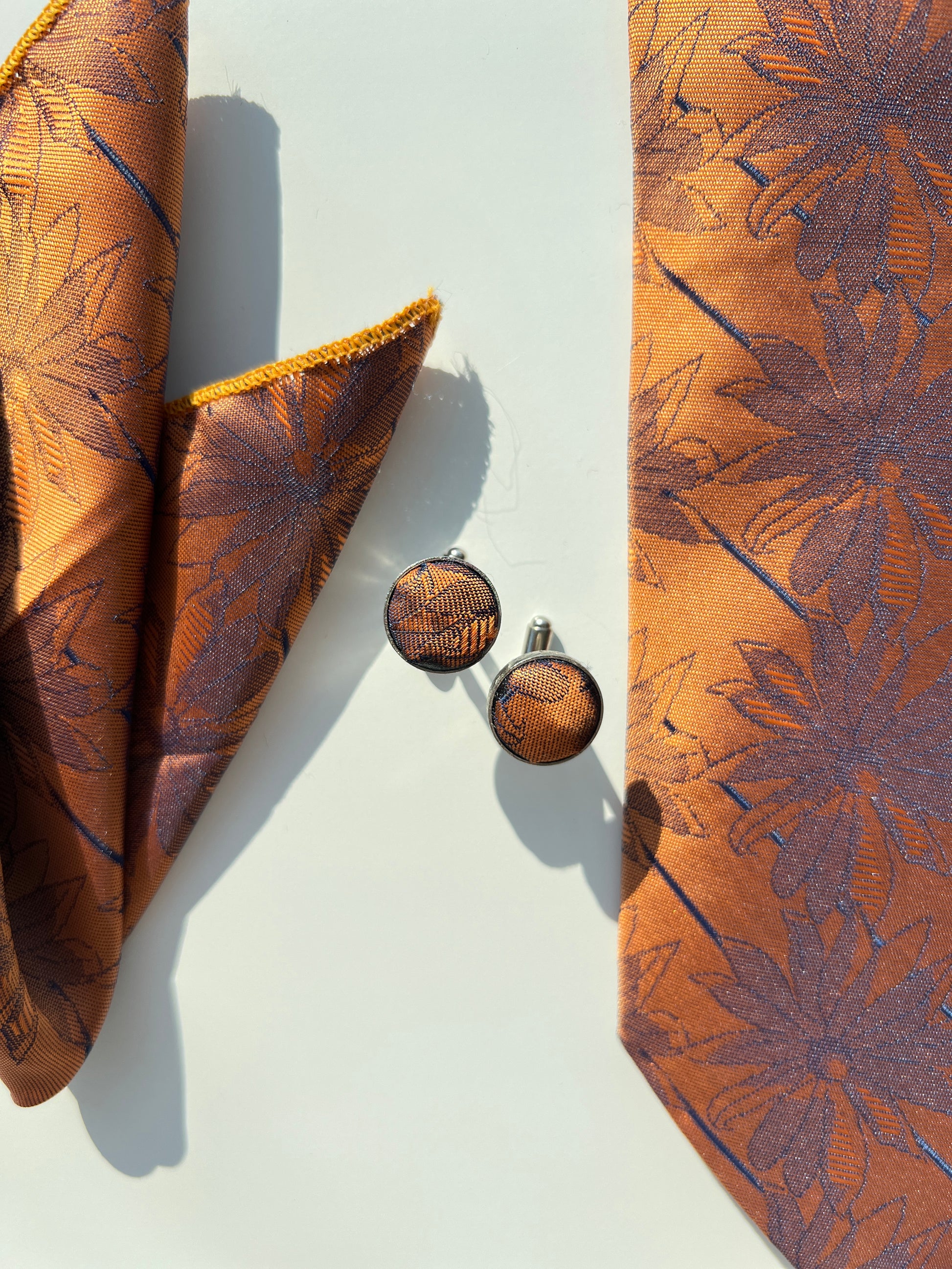 Bronze floral elegance tie set closeup shot with cufflinks 